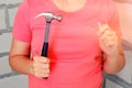 Hammer and nail in hand, close-up. The woman holds a large hammer and nails in his hands Royalty Free Stock Photo