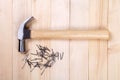 Hammer with nail on wood background Royalty Free Stock Photo