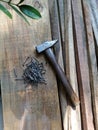 Hammer, nails lying on the wood