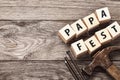 Hammer, nails and wooden cubes with inscriptions on the table. Papa Fest concept with copy space Royalty Free Stock Photo