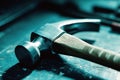 Hammer resting on a workbench in a dimly lit workshop showcasing craftsmanship and tools in use Royalty Free Stock Photo