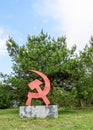 Hammer and sickle monument in park Royalty Free Stock Photo