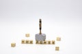 The hammer is standing on the wooden cubes with the words THE POWER against white background