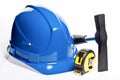 Hammer, tape line and blue hardhat