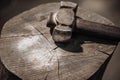 Hammer on a wooden stump.