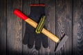 Hammer and work gloves for the master carpenter on a black wooden board