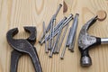 Hammer ,wrench and nails on wood background Royalty Free Stock Photo