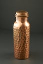 Hammered Copper Bottle on Gray Background Royalty Free Stock Photo