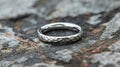 Hammered Silver Band Wedding Ring On Rock Royalty Free Stock Photo