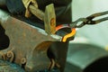 Hammering glowing steel - to strike while the iron is hot.