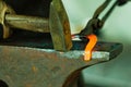 Hammering glowing steel - to strike while the iron is hot. Royalty Free Stock Photo