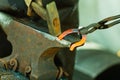 Hammering glowing steel - to strike while the iron is hot. Royalty Free Stock Photo