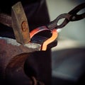 Hammering glowing steel - to strike while the iron is hot. Royalty Free Stock Photo