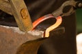 Hammering glowing steel - to strike while the iron is hot. Royalty Free Stock Photo