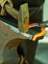 Hammering glowing steel - to strike while the iron is hot. Royalty Free Stock Photo