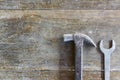 Old hammer and wrench on old wood background Royalty Free Stock Photo