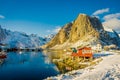 HAMMNOY, LOFOTEN, NORWAY, APRIL, 10, 2018: Above view of some Fishing hut rorbu and Lilandstinden mountain peak at