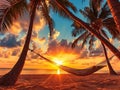 Hammock on beach at beautiful sunset near ocean shore attached to a palm tree. Caribbean vacation Royalty Free Stock Photo