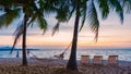 Hammock and beach chairs on the beach with palm trees during sunset at Na Jomtien Beach Pattaya Thailand Royalty Free Stock Photo