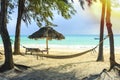 Hammock, chair and umbrella beach equipment made of natural materials at a tropical beach Royalty Free Stock Photo