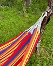 hammock, fabric hammock hanging on the plot, relax in the open air, rag bed hung between trees Royalty Free Stock Photo