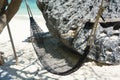 Hammock hanging with tree in shade at seaside sandy beach