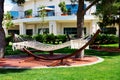 The hammock is on lawn in luxury hotel