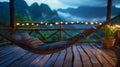 A hammock perched on a balcony offering breathtaking views of a mountain range and the promise of a restful nights sleep