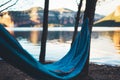 Hammock for relaxing on background of nature lake, chilling outdoor, traveler recreation mountain landscape; camping lifestyle