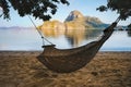 A hammock in the shade with tropical cadlao island in morning light the background Royalty Free Stock Photo