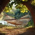 Hammock strung between trees overlooking a calm river view Royalty Free Stock Photo