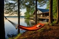 hammock tied to trees, with cottage and dock in sight