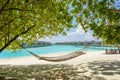 Hammock at the tropical beach with over water bungalows at background Royalty Free Stock Photo