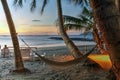 Hammock on tropical beach at sunset