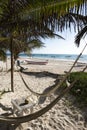 Hammocks on a Caribbean beach in the shade of palm trees Royalty Free Stock Photo