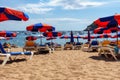 Hammocks and umbrellas on the sand of the beach on a hot summer day, Spain. Royalty Free Stock Photo