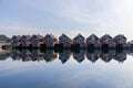 The glassy waters of Hamnoy perfectly mirror the red rorbuer, traditional Norwegian fishermen\'s cabins Royalty Free Stock Photo