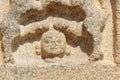 Hampi Vittala Temple carving of human head below the legs of two fighting wild animals