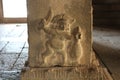 Hampi Vittala Temple Carving of a strange figure, holding a knife and cutting jackfruit Royalty Free Stock Photo