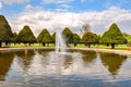 Hampton Court gardens pond with fountain in spring, London, UK