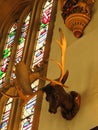 Hampton Court Palace - Antlers and stained glass window detail. UK Royalty Free Stock Photo