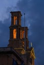 Hamrun Church bell tower with fairy light during national festival against blue night sky in Malta