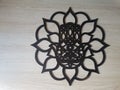 The hamsa or champas in a wooden mandala, in black color on a white background. Royalty Free Stock Photo