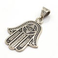 Hamsa hand pendant isolated on white Royalty Free Stock Photo