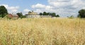 View of Shaker round barn and oat grain field banner image Royalty Free Stock Photo