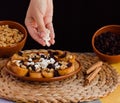 Hand adding cheese to a capirotada, traditional mexican dessert Royalty Free Stock Photo