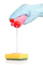 Hand adding detergent to a sponge