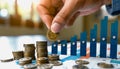 Hand adding gold coin to stack with bright upward trend line Royalty Free Stock Photo