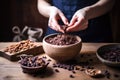 a hand adding organic raw cacao nibs to an acai bowl