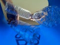 Hand is adding plastic bottles to recycling bin Royalty Free Stock Photo